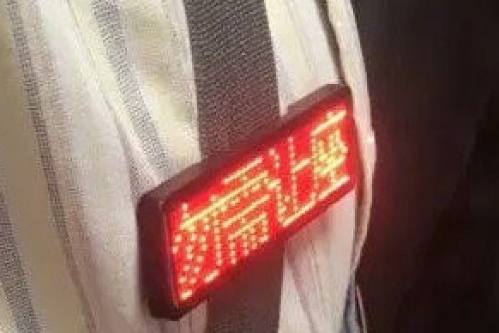 The man’s badge reading “no need to give up your seat” captured attention. Photo: Weibo