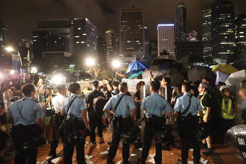 Protesters clash with police officers on Friday at the Central harbourfront site that, hours later, was handed over to the PLA for use. Photo: Dickson Lee
