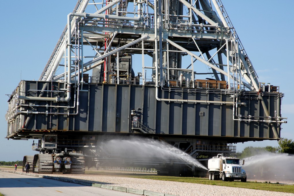 Water is sprayed in the path of NASA’s mobile launcher. Photo: Reuters