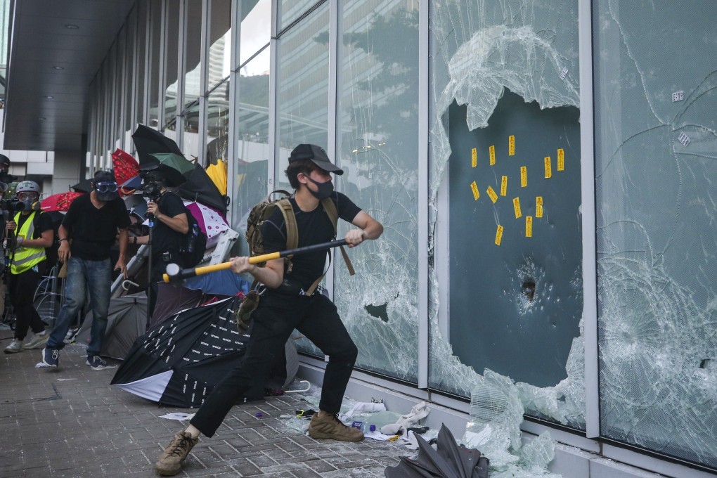Protesters break windows in an attempt to storm the Legislative Council complex. Photo: Winson Wong
