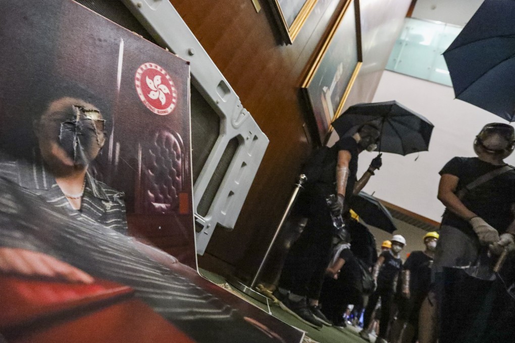 Protesters smashed doors and windows, defaced photographs and scrawled obscenities on walls of the Legislative Council building in Tamar. Photo: Felix Wong
