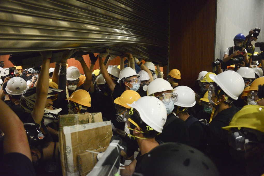 Protesters storm the Legislative Council Chamber in Tamar, Hong Kong during a protest against the extradition bill on Monday. Photo: Antony Dickson