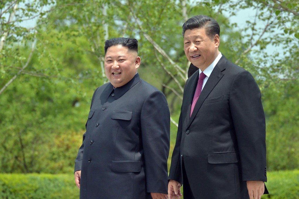 North Korean leader Kim Jong-un walks with visiting Chinese President Xi Jinping in the grounds of the Kumsusan State Guest House in Pyongyang on June 21. The visit came ahead of Xi’s meeting with US President Donald Trump at the G20 summit, and also Kim’s surprise meeting with Trump at the demilitarised zone last weekend. Photo: Korean Central News Agency via KNS / AFP
