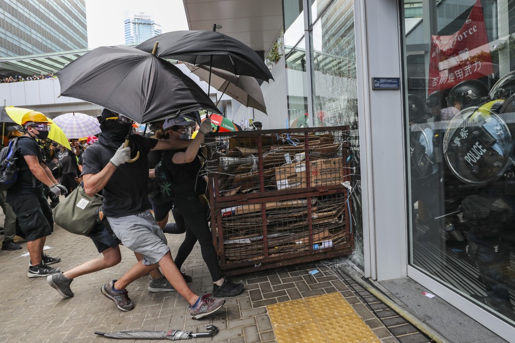 Protesters smash windows of the Legislative Council complex in Tamar on Monday. Photo: Sam Tsang