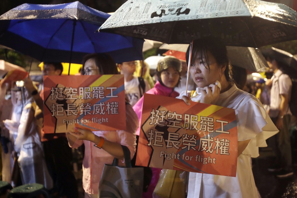 EVA Air flight attendants and their supporters protest outside the office of Taiwan’s President Tsai Ing-wen on Tuesday. Photo: AP