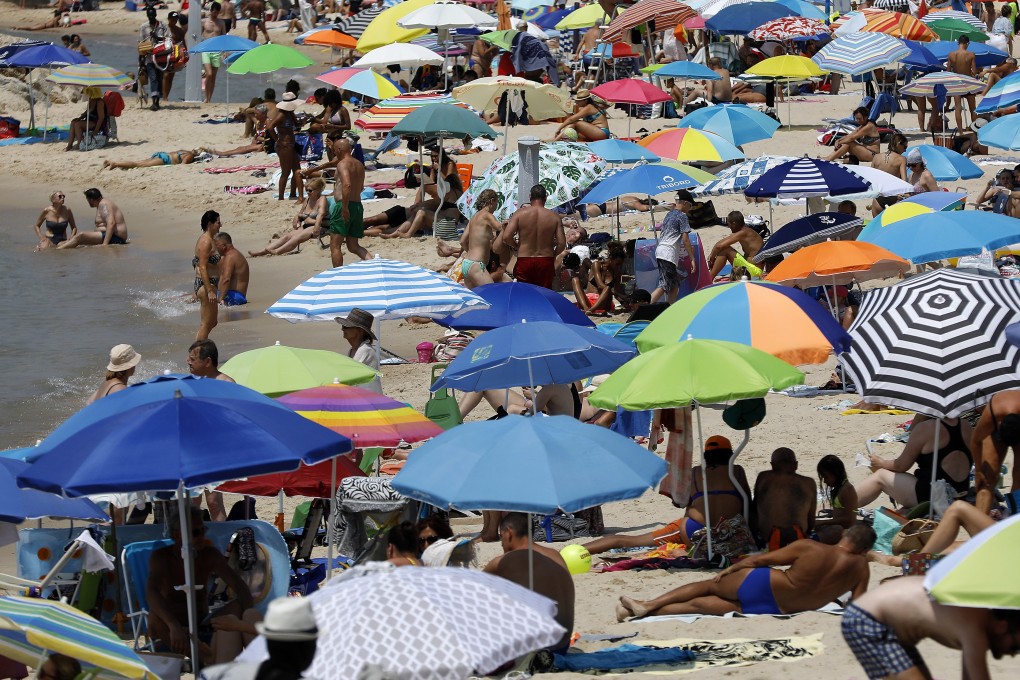 People enjoy the sun and the sea on a beach in Antibes, southern France. Photo: EPA-EFE