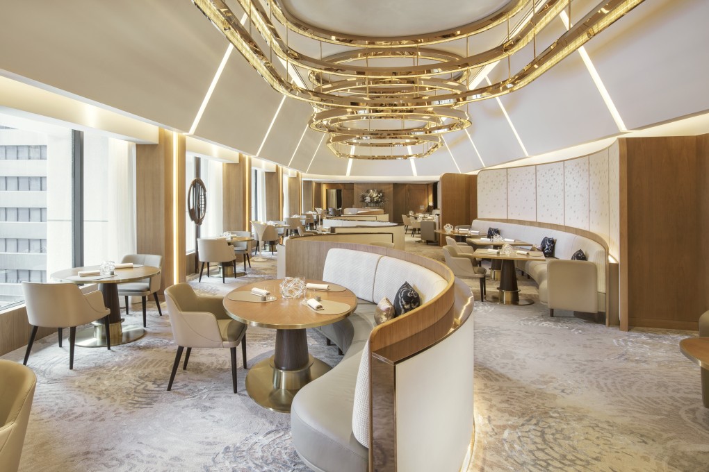 Amber's famous gold-rod lighting have been replaced by bronze ring chandeliers that draw attention to the ceiling height.