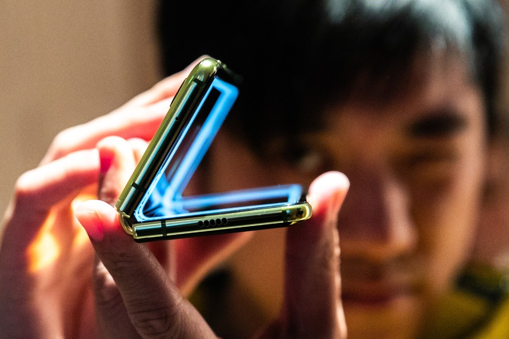 An attendee holds Samsung Electronics’ Galaxy Fold smartphone during an unveiling event in New York on April 15, 2019. Photo: Bloomberg