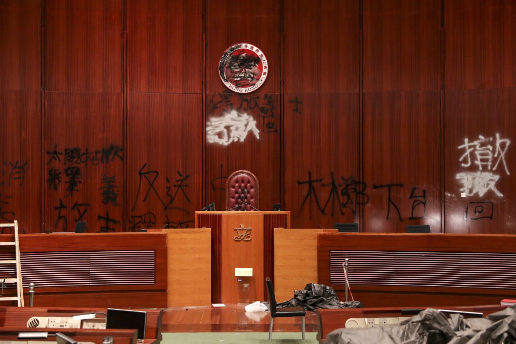 The Legislative Council chamber was vandalised and the city’s official emblem was sprayed with black plant. Photo: Sam Tsang