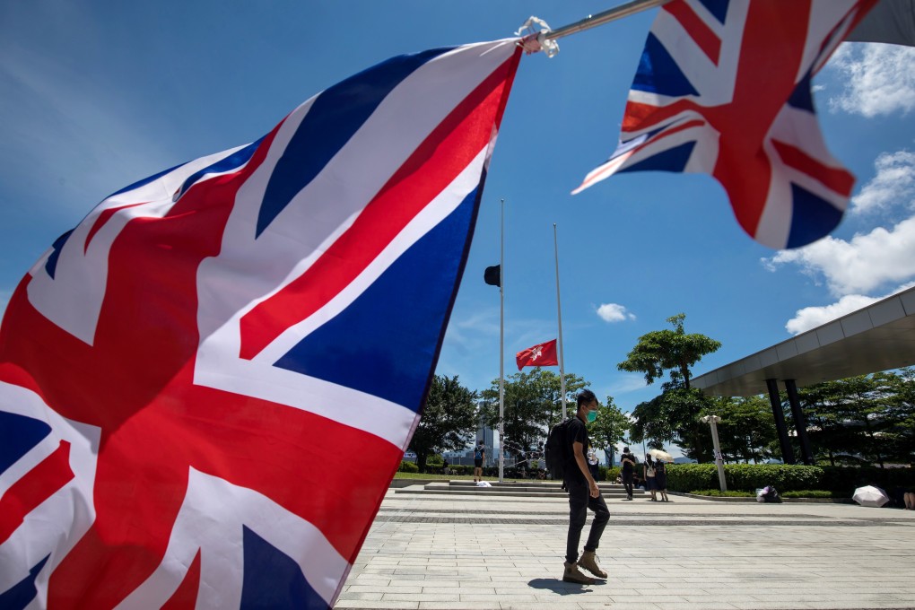 The British national flag flies in the foreground during a protest on July 1, as Hong Kong, a former British colony, marks the 22nd anniversary of its return to Chinese sovereignty. Photo: Bloomberg