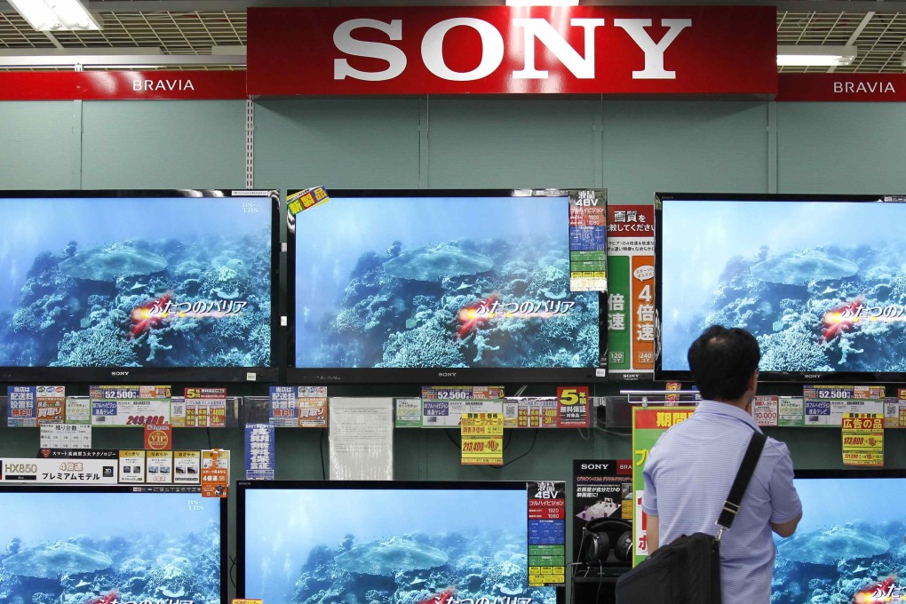 A man looks at Sony TV sets in Tokyo. File photo: Reuters