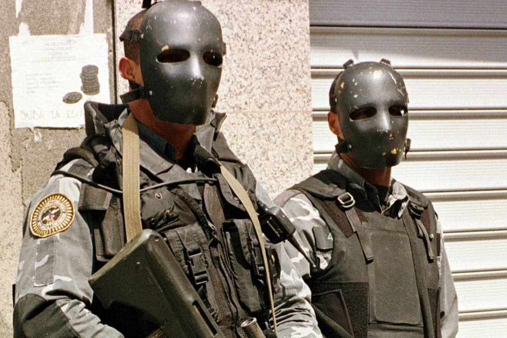 Venezuelan special forces police watch a demonstration in April 1998. Photo: AFP