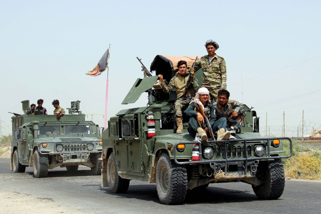 Afghan security officials patrol on Lashkargah-Kandahar highway in Helmand province. Photo: EPA-EFE