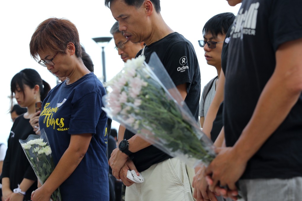 Those who gathered at the university laid flowers and observed three minutes of silence for the two women. Photo: Edmond So