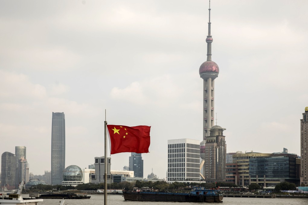 A Chinese national flag flies against the backdrop of skyscrapers at the Lujiazui financial district across the Huangpu River in Shanghai’s Pudong district. Venture capital deals in China plunged in the second quarter, as investors pulled back amid unpredictable trade talks and growing concerns about tech start-up valuations. Photo: Bloomberg