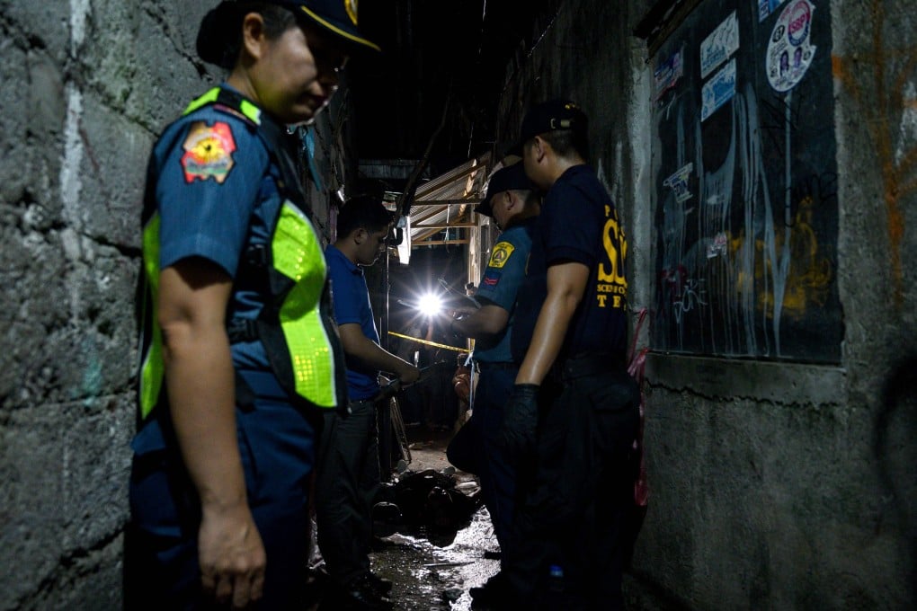 Policemen at the scene of a drug-related killing in Manila. Photo: AFP
