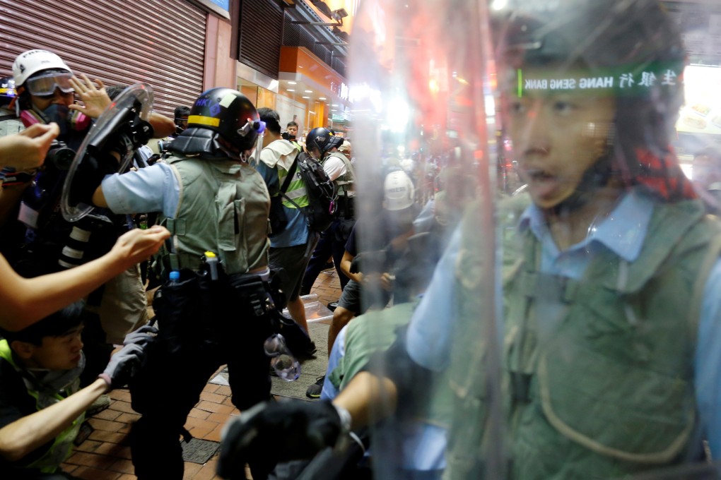 Riot police officers try to disperse extradition bill protesters during a demonstration in the Mong Kok area of Hong Kong. Photo: Reuters