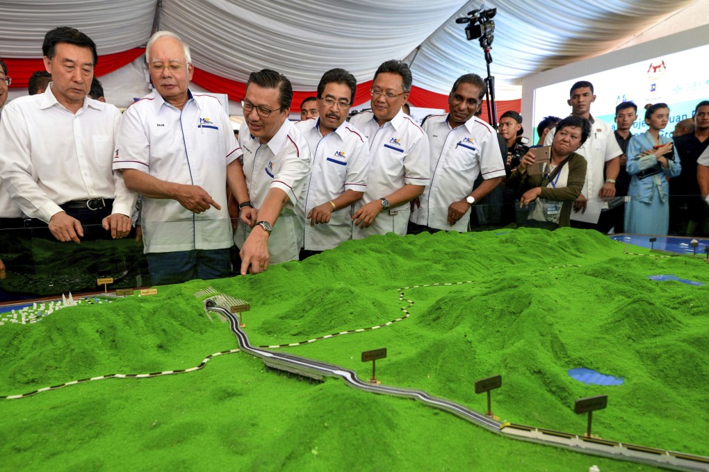 Najib Razak, Malaysia’s former prime minister, looks at a model of the China-backed East Coast Rail Link project. Photo: AP