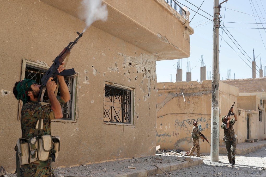 Kurdish fighters fire rifles at a drone operated by Islamic State militants in Raqqa, Syria, in June 2017. Asia is grappling with how to handle the hundreds of ISIS followers returning home from fighting in the Middle East. Photo: Reuters