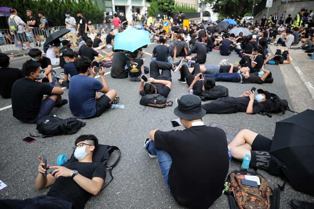 Extradition bill demonstrators take a break outside the Department of Justice in Hong Kong last month. The use of encrypted messaging, peer-to-peer communication technology, doxing and cyber attacks have shown that the protest is also very much in the digital realm. Photo: Sam Tsang