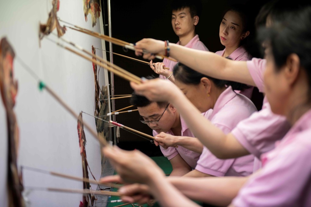 Beijing Shadow Show Troupe puppeteers conduct a performance for schoolchildren. Photo: AFP