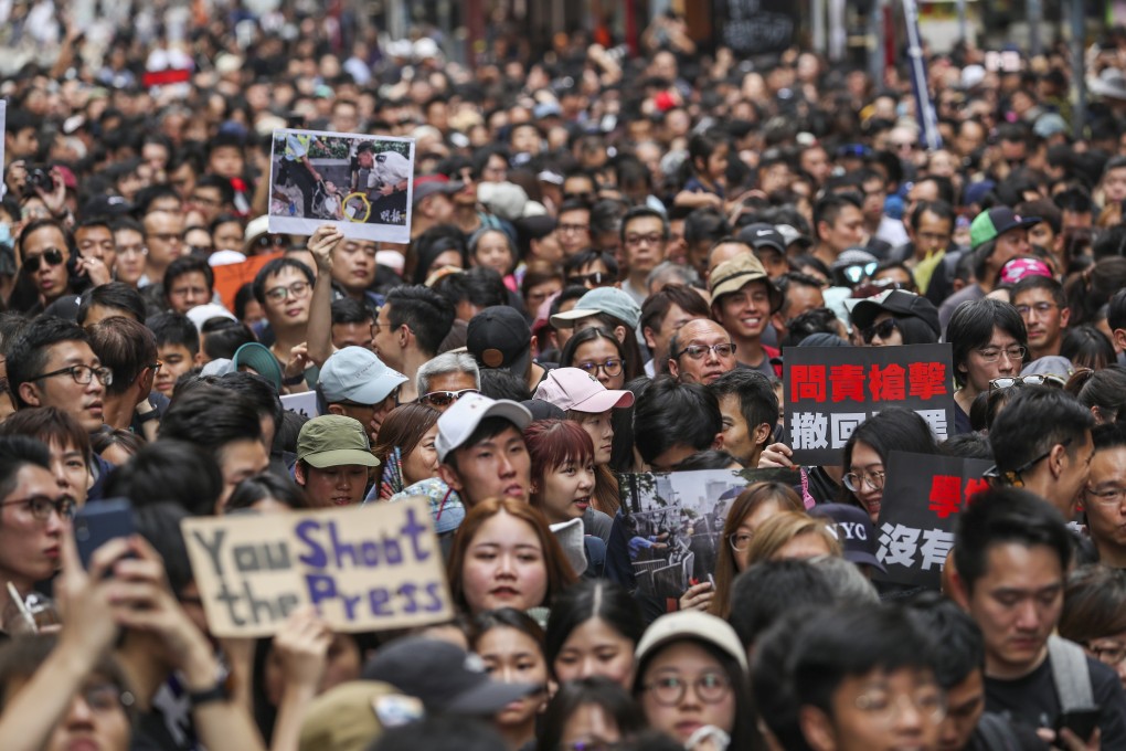 Where else can nearly a third of the population march more than 3km on a sweltering day through a busy commercial district without breaking a single shop window, overturning a car or burning a tyre? Photo: Robert Ng