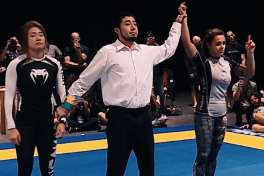Michelle Nicolini has her arm raised after beating Angela Lee in a grappling match. Photos: One Championship