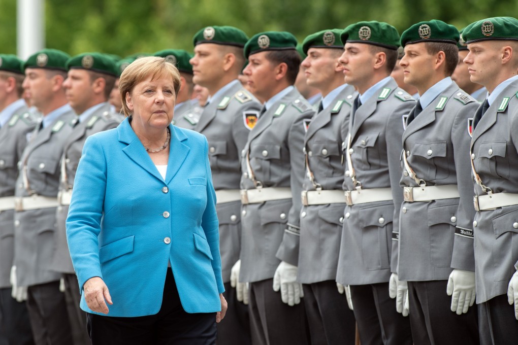German Chancellor Angela Merkel walks past German soldiers of the guard of honour before the arrival of Finnish PM Antti Rinne. Photo: dpa