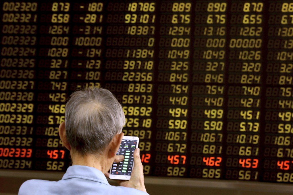 A man monitors stock prices at a brokerage in Beijing on Tuesday, June 25, 2019. Photo: AP