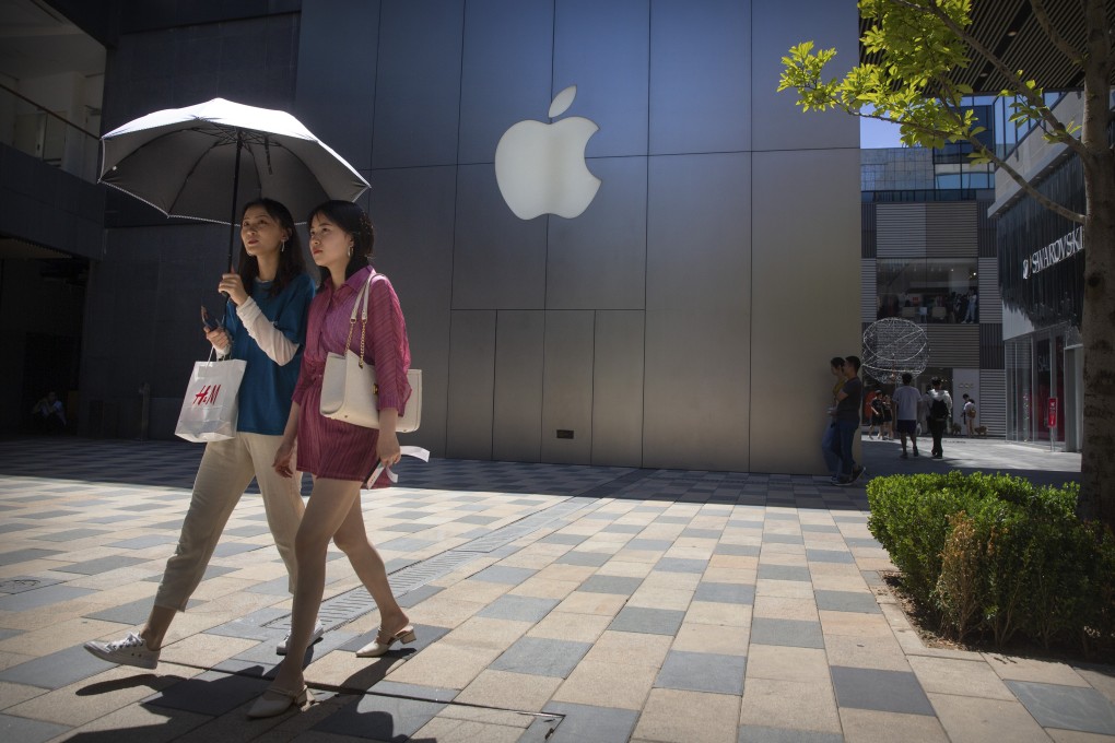 People walk past an Apple store in Beijing. Presidents Donald Trump and Xi Jinping have agreed to a new truce in a year-long trade war between the US and China. Photo: AP