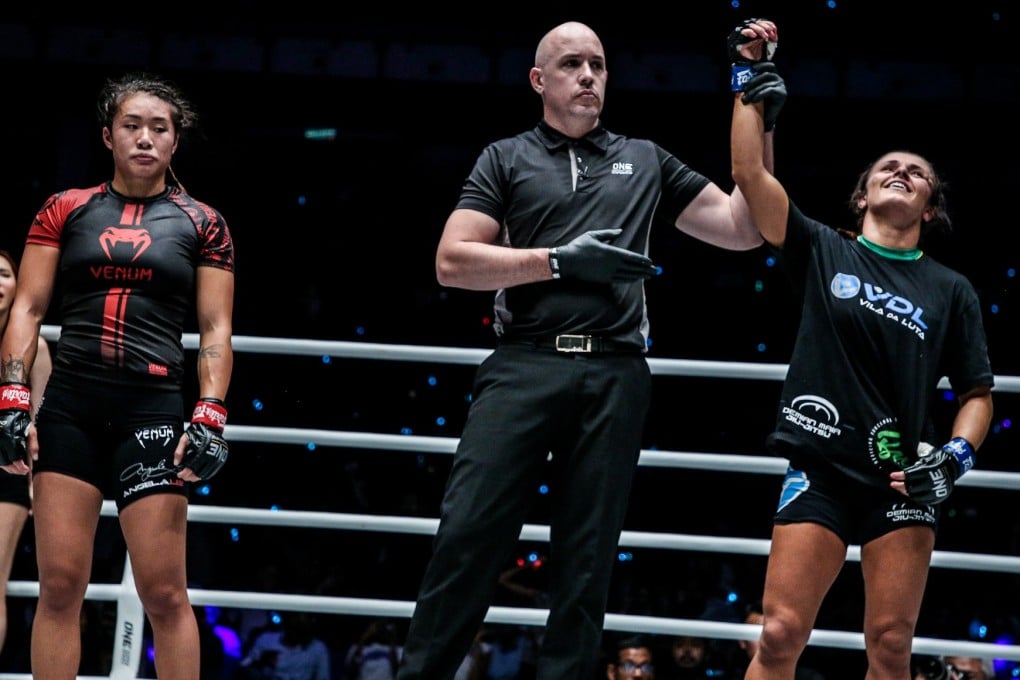 Michelle Nicolini's arm is raised as Angela Lee looks dejected. Photos: One Championship