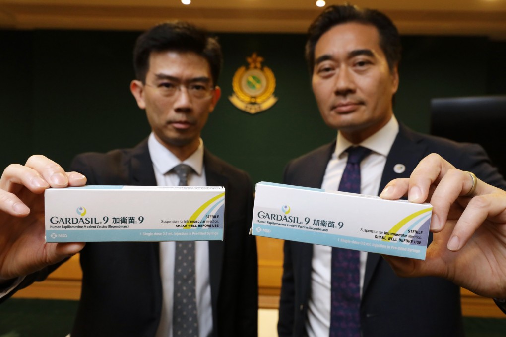 Lot Chan (left), chief pharmacist at the Department of Health’s drug office, poses with a box of genuine vaccine on Friday, and Kwan Kin-keung, head of intellectual property investigation bureau at the Customs and Excise Department, shows what is believed to be a box of counterfeit vaccine. Photo: May Tse