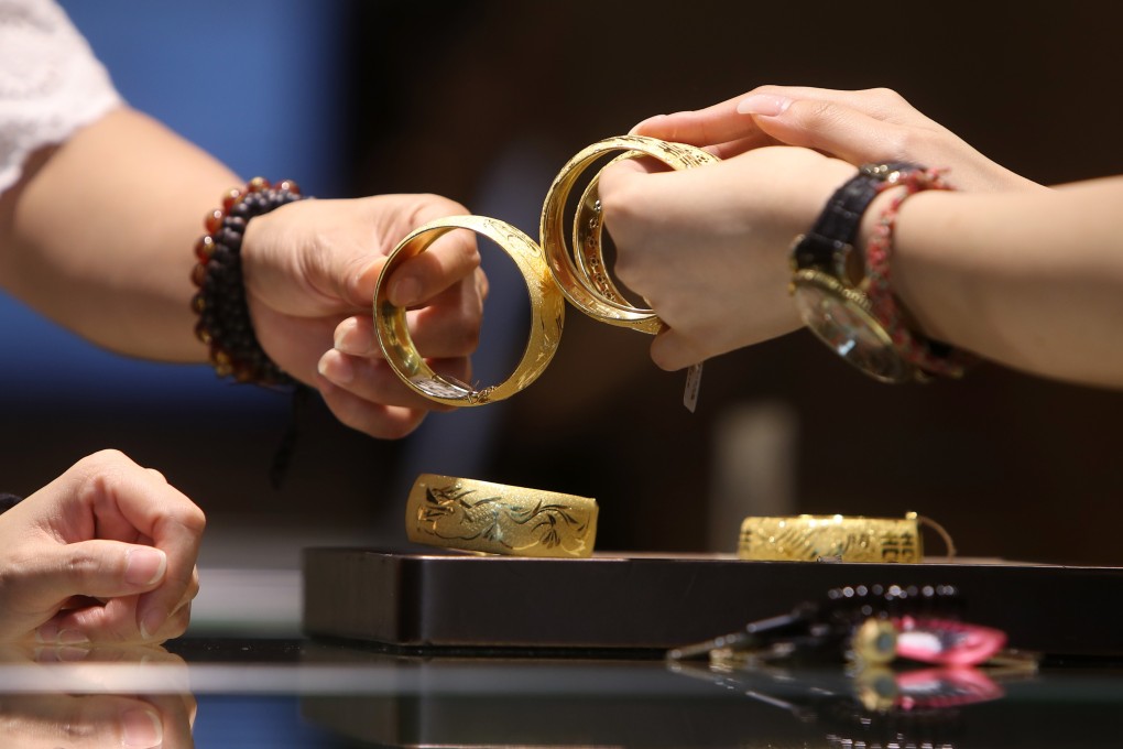 A customer inspects jewellery in Tsim Sha Tsui. The price of gold hit a six-year peak in recent weeks. Photo: Winson Wong