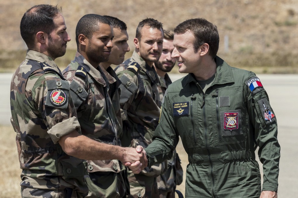 French President Emmanuel Macron with members of the military during a visit to an air force base in Istres, France in July 2017. Photo: EPA
