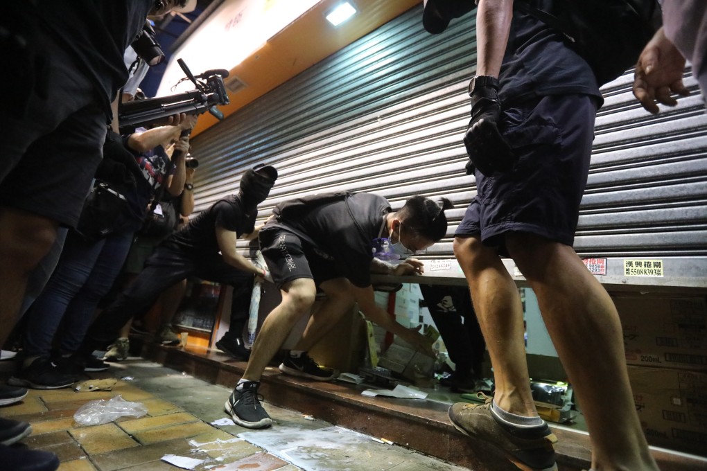 Protesters target a Lung Fung Dispensary outlet in Sheung Shui. Photo: Felix Wong