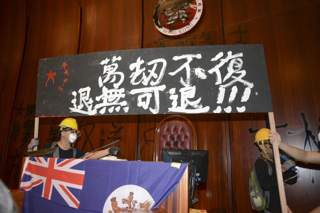 On July 1, protesters stormed the Legislative Council chamber and put up Hong Kong’s colonial-era flag underneath a banner saying, “Forced to the point of no return”. Photo: Antony Dickson
