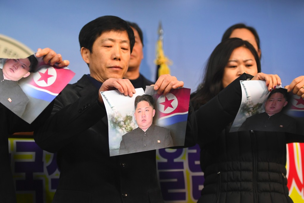 North Koreans who defected to the South tear pictures of Kim Jong-un in Seoul. Photo: AFP