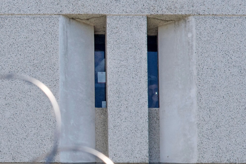 Two prisoners from earlier raids look out from a cell window at the main ICE detention centre in downtown Los Angeles. Photo: AFP