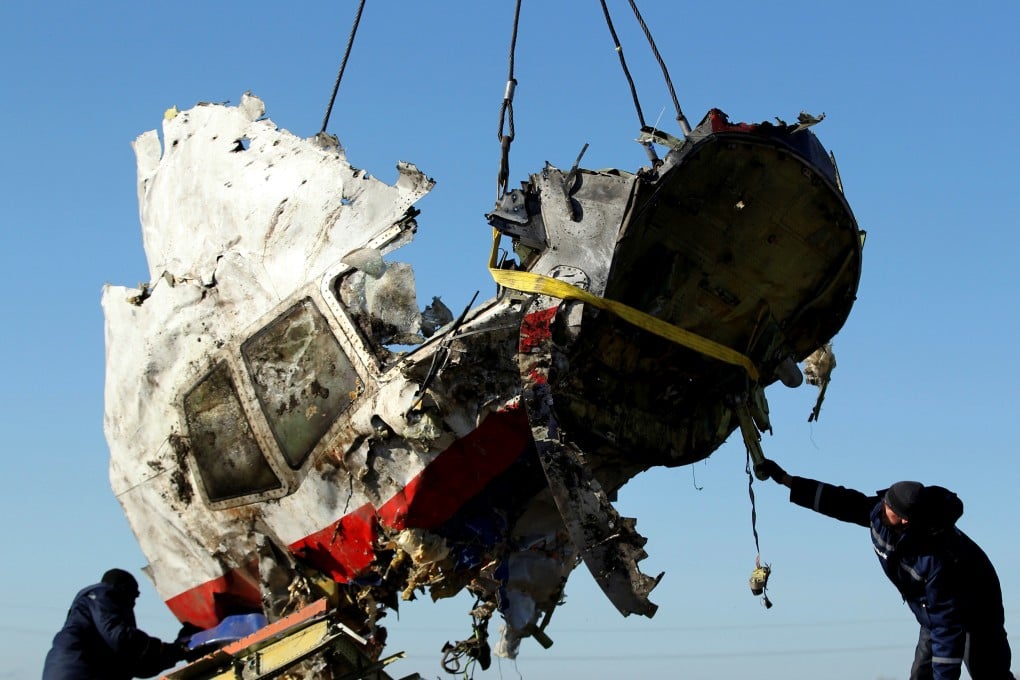 Workers transport a piece of the wreckage of Malaysia Airlines flight MH17 in eastern Ukraine. Photo: Reuters
