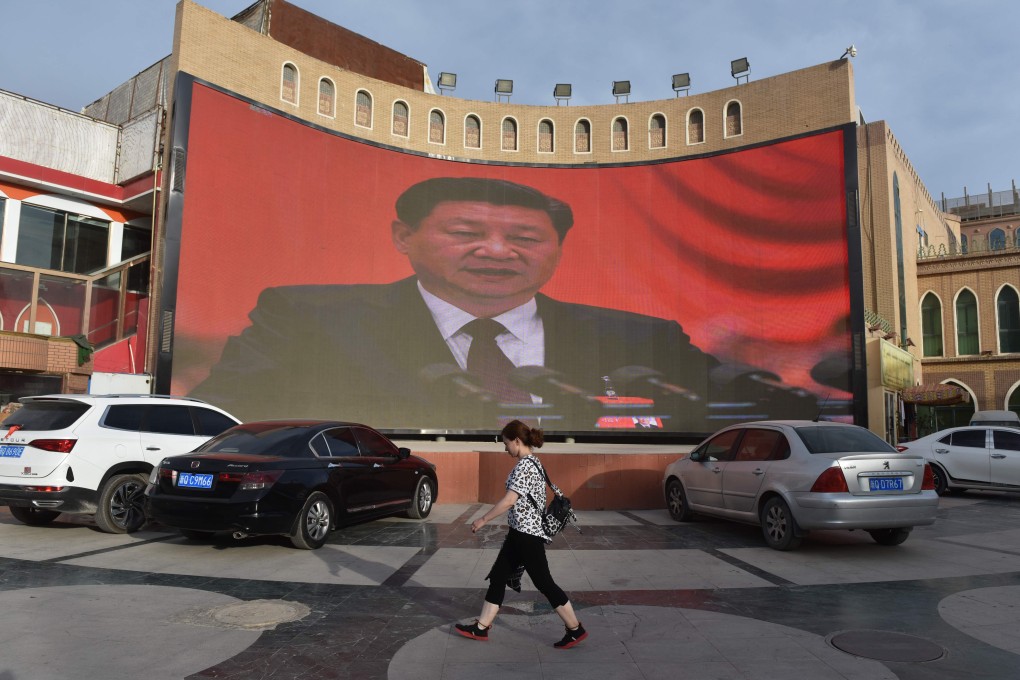 A screen showing images of Chinese President Xi Jinping in Kashgar, in China’s western Xinjiang region. Photo: AFP