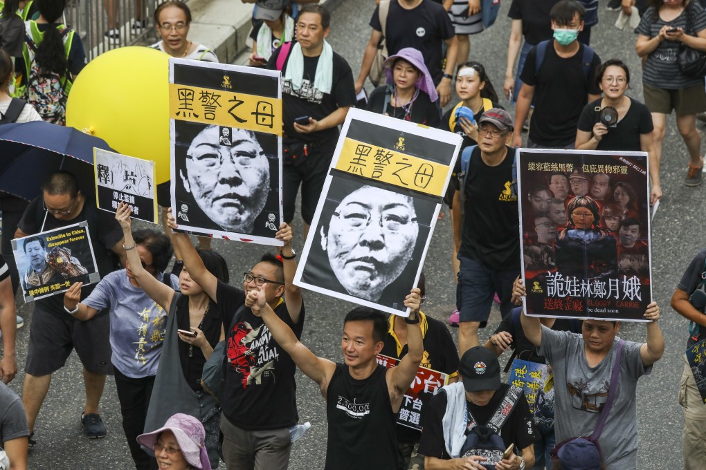 Protesters hold up posters lampooning Hong Kong Chief Executive Carrie Lam, at a rally in Sha Tin on July 14. Photo: Dickson Lee