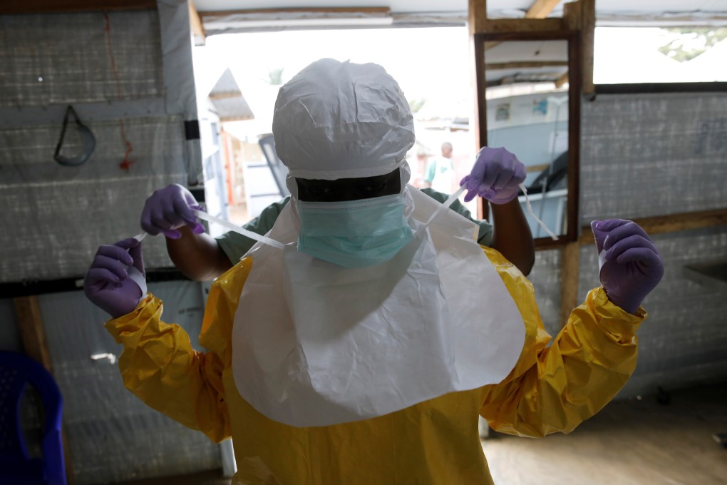 A health worker puts on Ebola protection gear at a treatment centre in Beni, Democratic Republic of Congo. Photo: Reuters