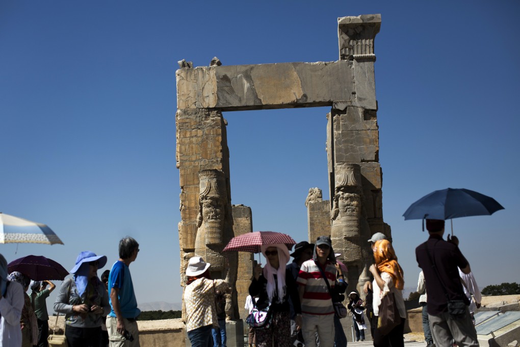 Chinese tourists visit the "Gate of All Nations" at the ancient Persian city of Persepolis near Shiraz in southern Iran, which is hoping to dramatically increase the number of visitors from China with a new visa waiver programme. Photo: AFP