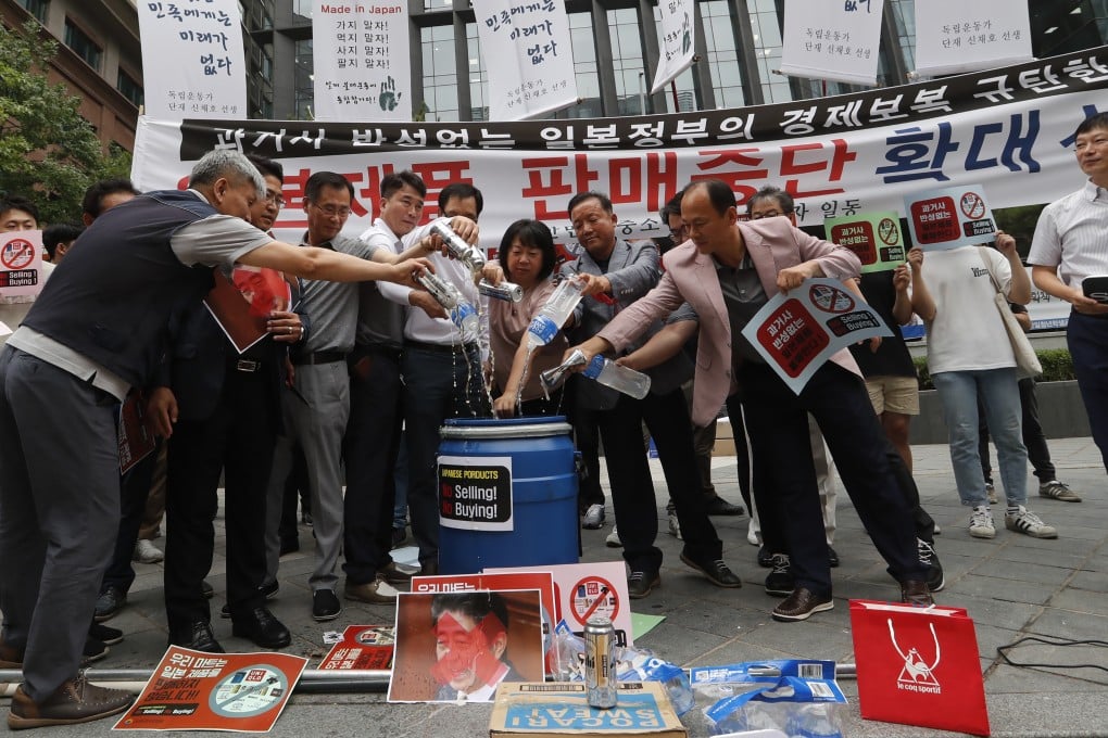 South Korean business owners call for a boycott of Japanese products in front of the Japanese embassy in Seoul. Photo: AP