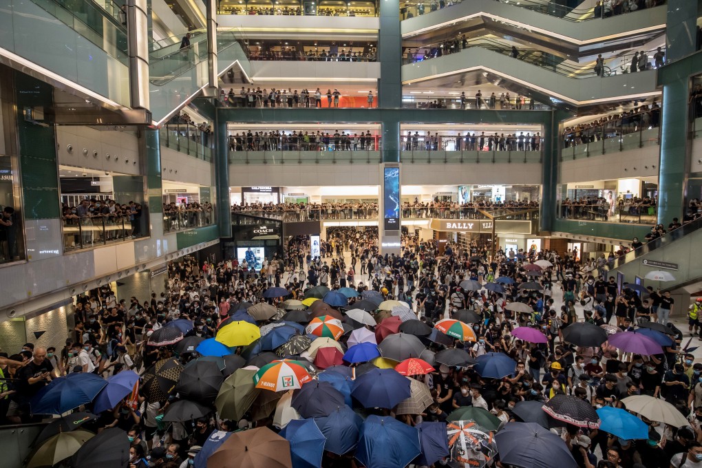 Demonstrators gather in the atrium of the New Town Plaza shopping mall on Sunday night. Photo: Bloomberg