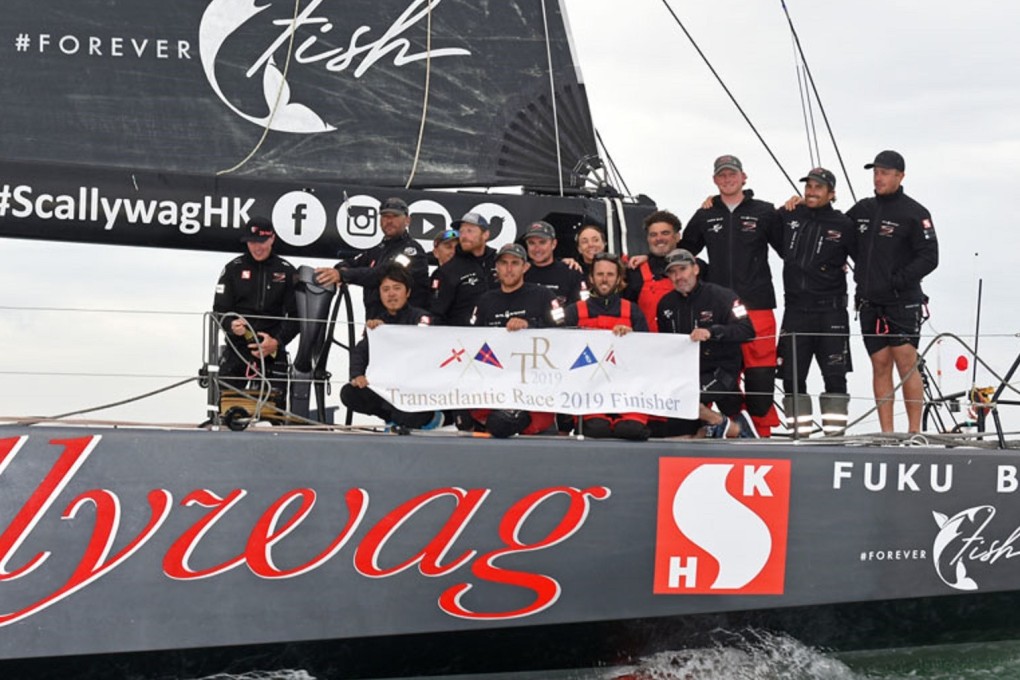 The Scallywag crew pose on the deck of their super maxi 100-footer after taking line honours in the Transatlantic Race 2019. Photo: Rick Tomlinson