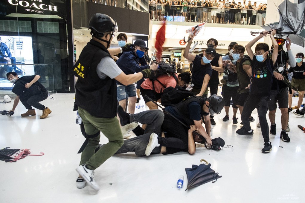 Protesters attack police at New Town Plaza shopping centre on Sunday. Photo: Bloomberg