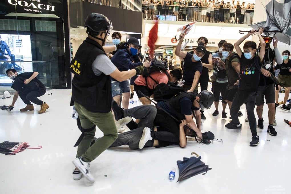 Protesters attack police at New Town Plaza shopping centre on Sunday. Photo: Bloomberg
