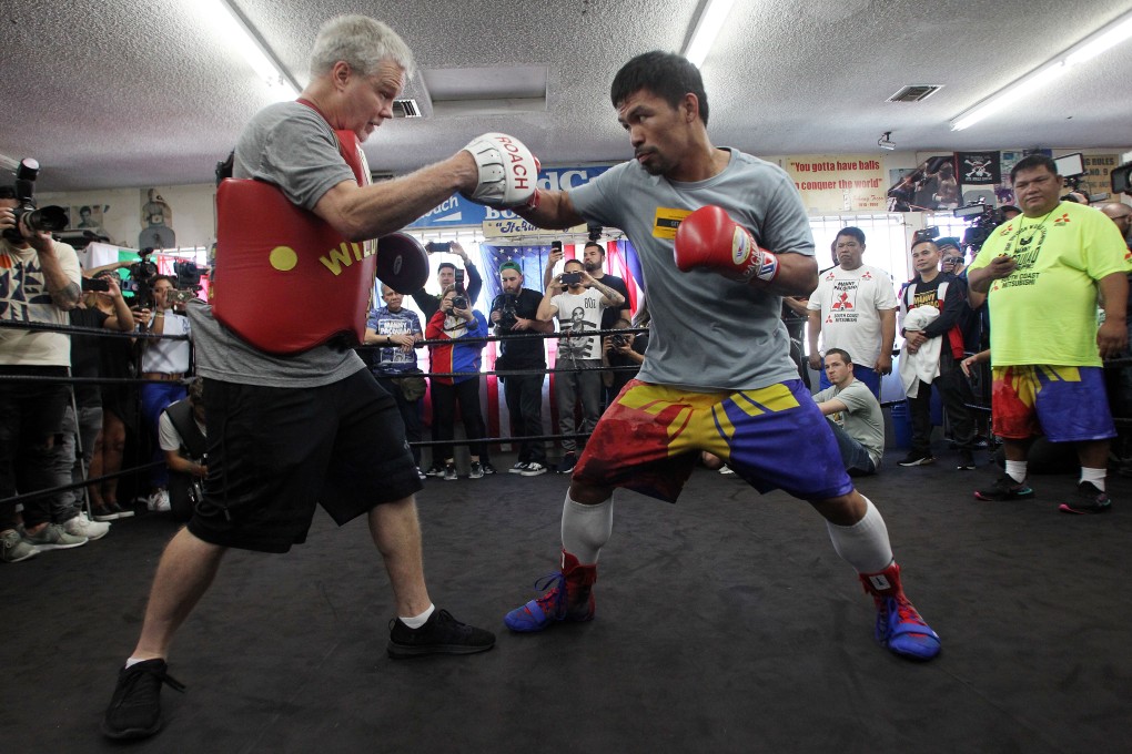 Manny Pacquiao hits the mitts with coach Freddie Roach during media day in Los Angeles. Photo: DPA