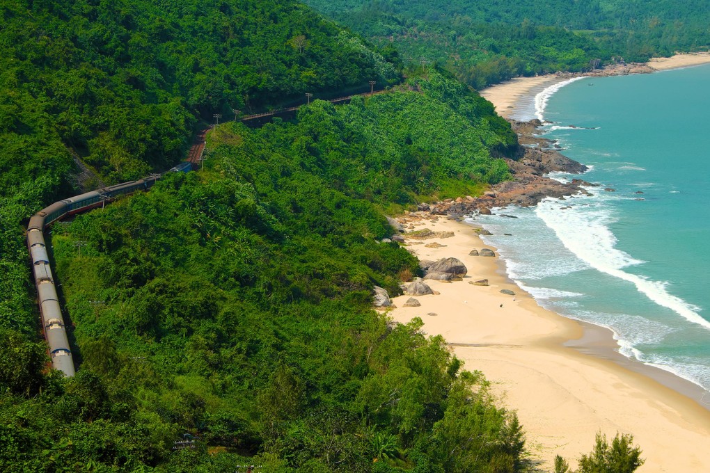 A train passes Lang Co beach, near the Hai Van Pass between Hue and Da Nang, central Vietnam. The Reunification Express offers passengers good views of the coast. Photo: Alamy